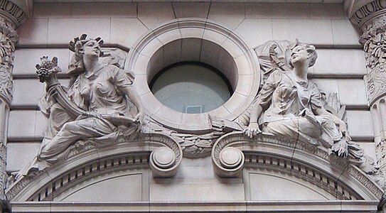 Beaux-Arts building decoration presenting images of the Roman goddesses Pomona and Diana. Note the naturalism of the postures and the channeled rustication of the stonework.