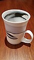 Porcelain mug by Margaret Brown, Australian, white with black second colouring