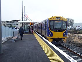 A passenger train at a small railway station