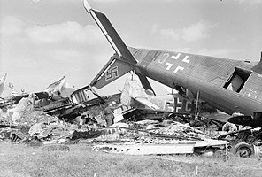 Two members of a Royal Air Force Disarmament Wing check an aircraft wreckage dump at Flensburg airfield