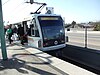 A westbound train at Long Beach Boulevard station