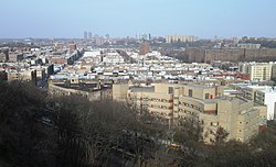 Overview of Inwood from Fort Tryon Park in 2018; in the right foreground is the Salome Urena de Henriquez Campus of the NYC Public Schools system; The Bronx is in the background