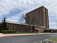 A dark brick office building with a large Ohio State logo