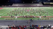 This image depicts the North Oconee Titan Regiment on the first set of their fall marching band show, "I Wanna Rock"