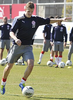 Petr Janda in mid-kick on a soccer pitch