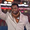 Headshot of Curtis Martin waving to a crowd