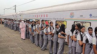 Students queue outside the train in 2014