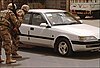 Soldiers peer into the car of Yasser Salihee, journalist and doctor, after his death in Baghdad in 2006