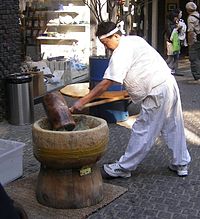 Pounding tteok (rice cake) in jeolgu (mortar) with tteokme (mallet)