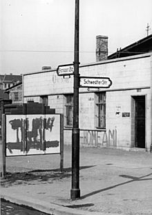 The anti-American slogan “Go home, Ami” in West Berlin on the former sector border (the streets of Bernauer Straße and Schwedter Straße (1950). The sign to the left saying (in German) "Entrance to the French sector" was painted over.