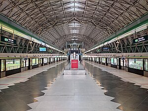 Photograph of the island platform of Tuas Link station, with a cylindrical roof