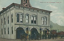 Exterior of Engine Company Number Five building with firefighters, horses, and engines arrayed in front of building, 601 Broadway Street, Toledo, Ohio. In use between 1873 and 1968.
