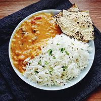 Dal tadka served with rice and papadam, a staple meal in the Indian subcontinent