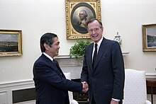 Eugene Wong (left) shaking hands with Preisdent George H.W. Bush (right) in the Oval Office.