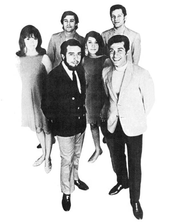 A group of four men and two women standing together