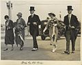 Sir John Goodwin and Lady Goodwin together with Neil Campbell and his wife, walking over the Grey Street Bridge in morning dress, top hats and spats (1931)