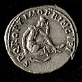 Trajan Denarius, Roman Dacia, 107 AD - Reverse. Image: Dacian wearing peaked cap, seated on shield in mourning, with falx below. Text: "SPQR OPTIMO PRINCIPI", abbreviation from "Senatus Populus Que Romanus. Optimo Principi"