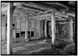 Interior view of coach and wagon storage area under house in 1977