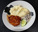 Pozharskaya kotleta served with mashed potatoes and a mushroom sauce