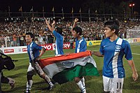 Bhaichung Bhutia and Sunil Chhetri holding the Indian National flag.