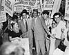 Robert Thompson and Benjamin Davis surrounded by pickets as they leave the Federal Courthouse in New York City