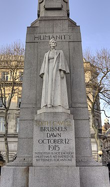 A marble statue of Edith Cavell in nurse's uniform backed by a large granite column
