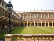 17th century grass court surrounded by cloistered buildings