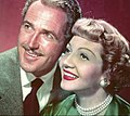Claudette Colbert and Patrock Knowles. Cobert has a bob, KNowles has a regular combed-back style. 1950