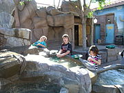 Jaydon, Ana Luisa and Nina in the gold panning interactive exhibit.