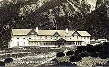 Photo of hotel in front of mountain.