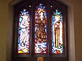 Stained glass west window depicting Mother Teresa, Edith Stein and Thérèse of Lisieux