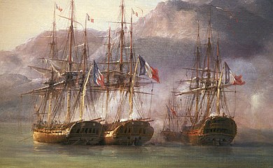 Four ships lie clustered together in shallow water under the shadow of a mountain.