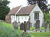 A simple small church with a red roof seen from the southeast