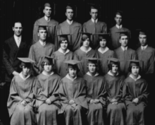 The photo is a black and white image of the Rogersville Class of 1927, showing three rows of 16 graduates alongside what appears to be the principal.