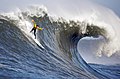 Image 13A man engaging in big wave surfing at Mavericks, located just north of Half Moon Bay, California. Big wave surfing is a discipline within surfing in which experienced surfers paddle into or are towed onto waves which are at least 20 ft (6.1 m) high, and is a hazardous activity, as surfers can be pushed far beneath the surface of the water after a wipeout.