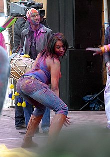 A woman twerking at a music festival.