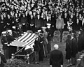 An honor guard folds the flag of the United States at Arlington National Cemetery in preparation for flag presentation to Jacqueline Kennedy on November 25, 1963.