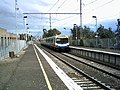 Southbound view from Platform 1, with an Upfield bound Comeng train arriving on Platform 2, June 2004