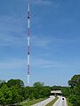 An antenna tower 1,075 feet (328 m) tall in Atlanta, GA with its red and white aircraft warning paint visible