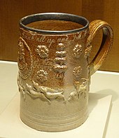 Mug with hunting scene and metal rim, dated 1724, inscription includes "Drink all up and Fill itt"