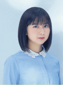 Moka Kamishiraishi in a light blue dress against a light blue backdrop.