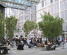 Bamboo trees and seating area in 590 Madison Avenue's atrium