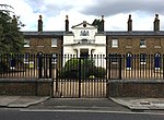 Goldsmiths' Almshouses and railings fronting road