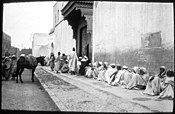 Local men lining up to be received inside Pasha Glaoui's palace, in a 1924 photo (palace gate visible in the middle)