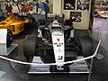 A McLaren MP4/14 on display at the Donington Collection. The car carries chassis number 4 and is in the state it crossed the line to win both the 1999 Japanese Grand Prix and the Formula One Drivers' Championship for its driver, Mika Häkkinen.