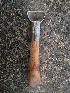 A halukhit or sharp scraper used to remove dried fat from a seal skin