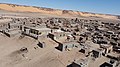 Some modern housing visible in the foreground with many other abandoned historical buildings