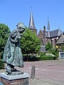 Beers, church and statue of child dressed up as elderly woman