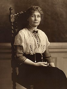 Monochrome photo of a lady sitting in a chair