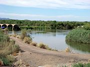 The Gillespie Dam was constructed in 1921. The dam is a concrete gravity dam located on the Gila River between the towns of Buckeye and Gila Bend, Arizona. On the morning of January 9, 1993, the dam failed when a segment approximately 120 feet (37 m) in length collapsed into the Gila River.